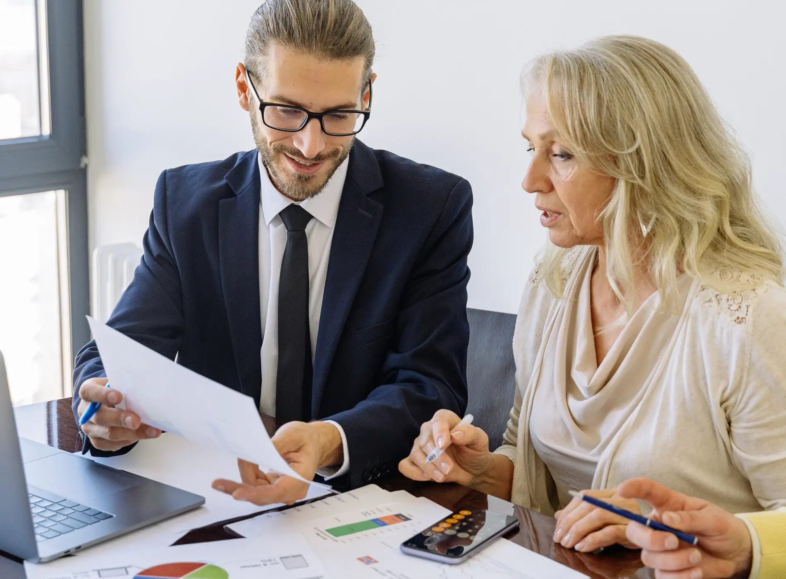 A CPA and a client reviewing financial statements and management reports together